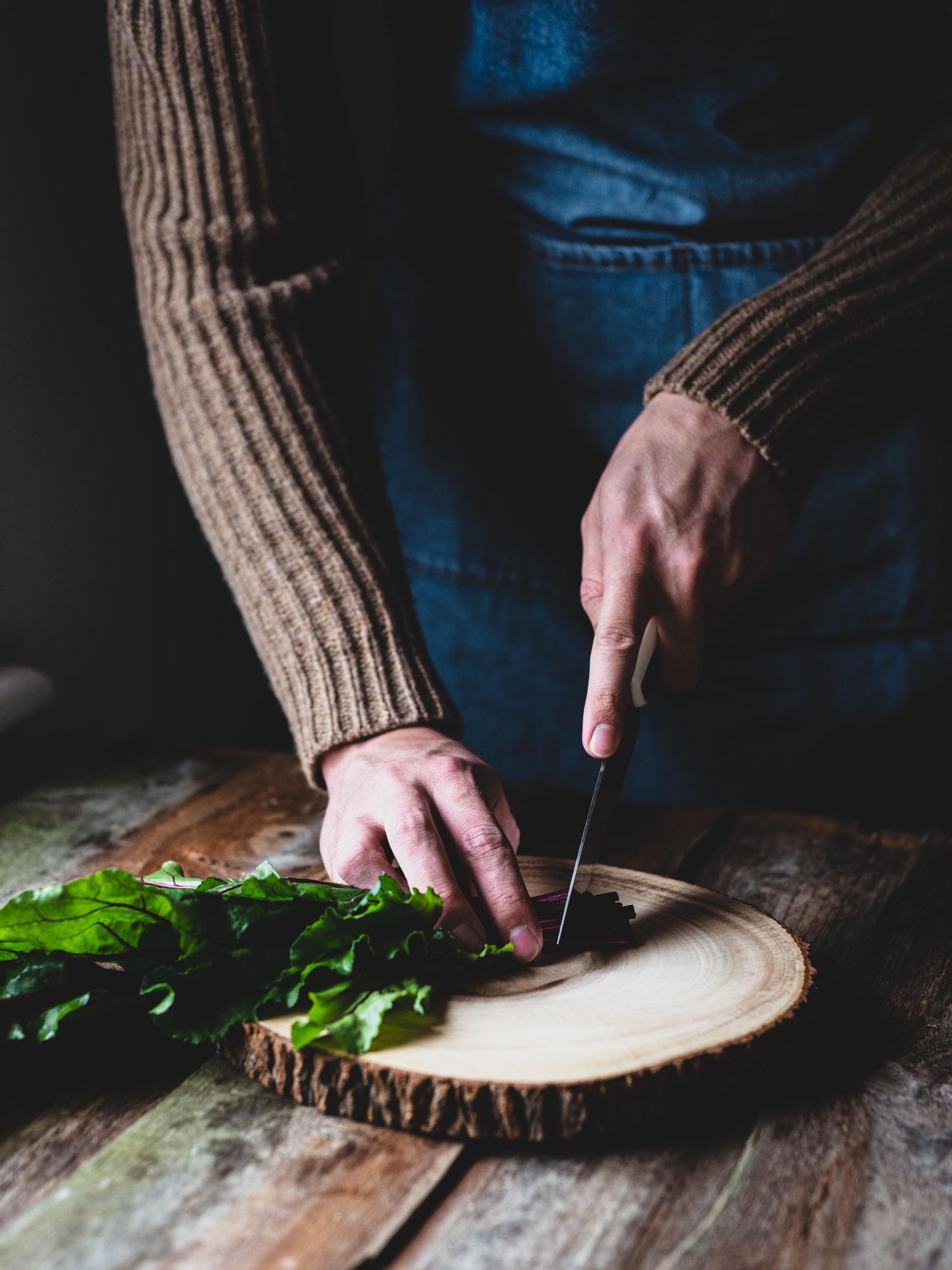 Chef arranging rustic dish on wooden board